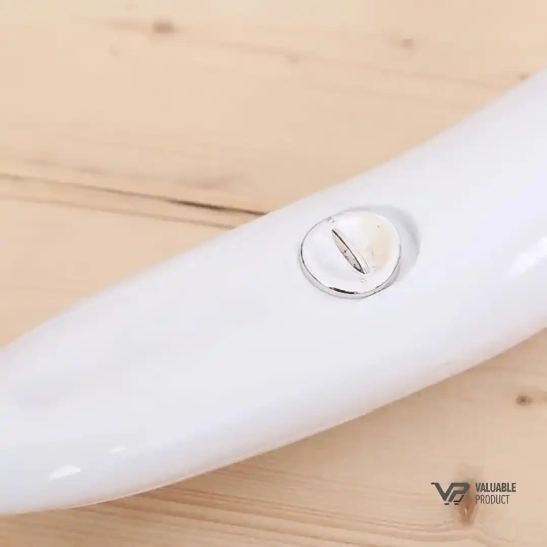 White electronic device with a button on a wooden surface, branded 'Vulnerable Product'.