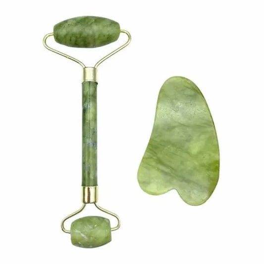 Green jade roller and gua sha tool on a white background