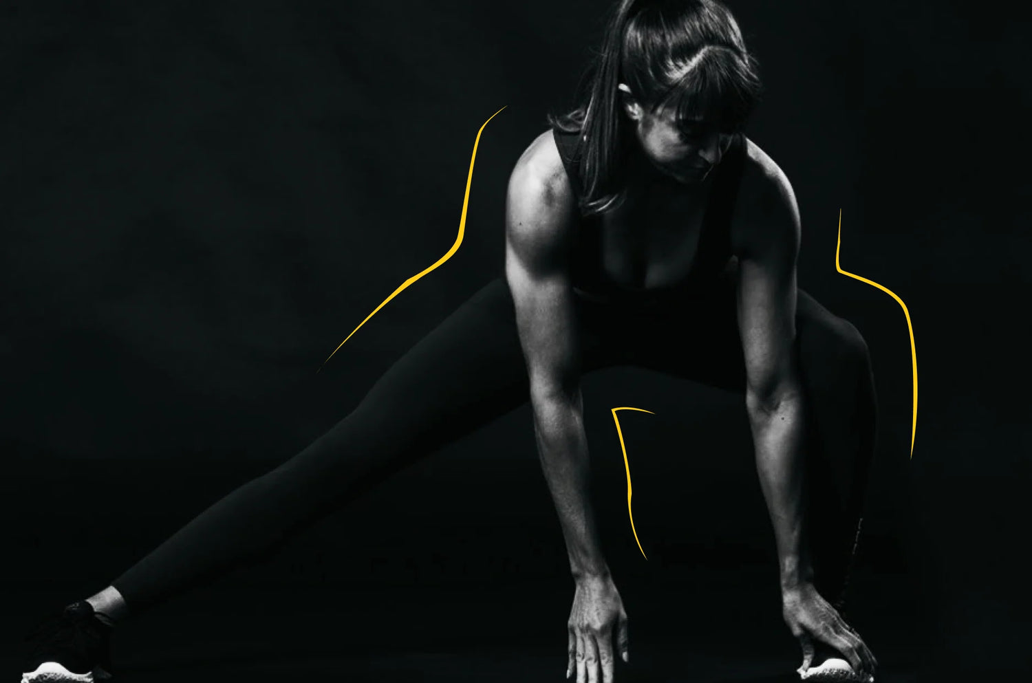 Person in athletic wear crouching on a black background with yellow accents